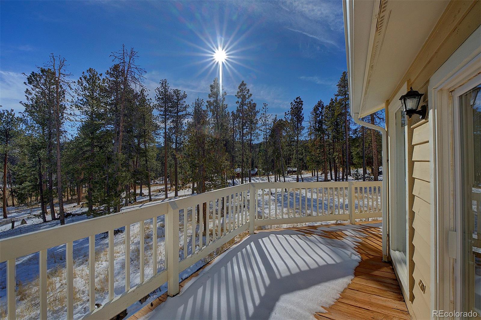 27987 Pine Grove Trail Conifer, CO 80433 - Photo 34 of 37 a view of balcony with wooden floor and outdoor space