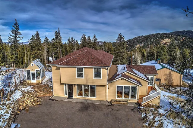 an aerial view of a house with a yard