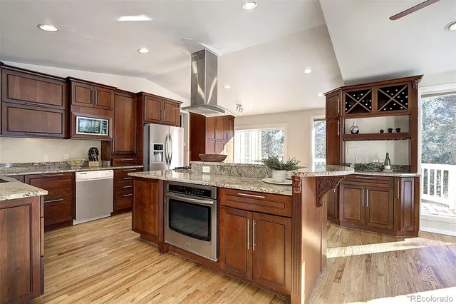a kitchen with stainless steel appliances granite countertop a stove and a sink