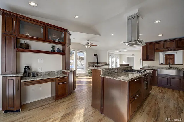 a kitchen with stainless steel appliances granite countertop a stove and a sink