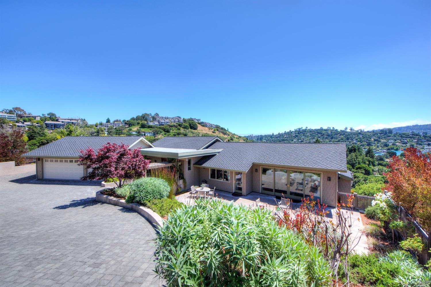 a view of a patio with furniture and a garden