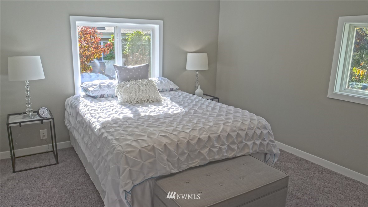1128 Lake View Circle Bothell, WA 98021 - Photo 13 of 25 a bed sitting in a bedroom next to a window
