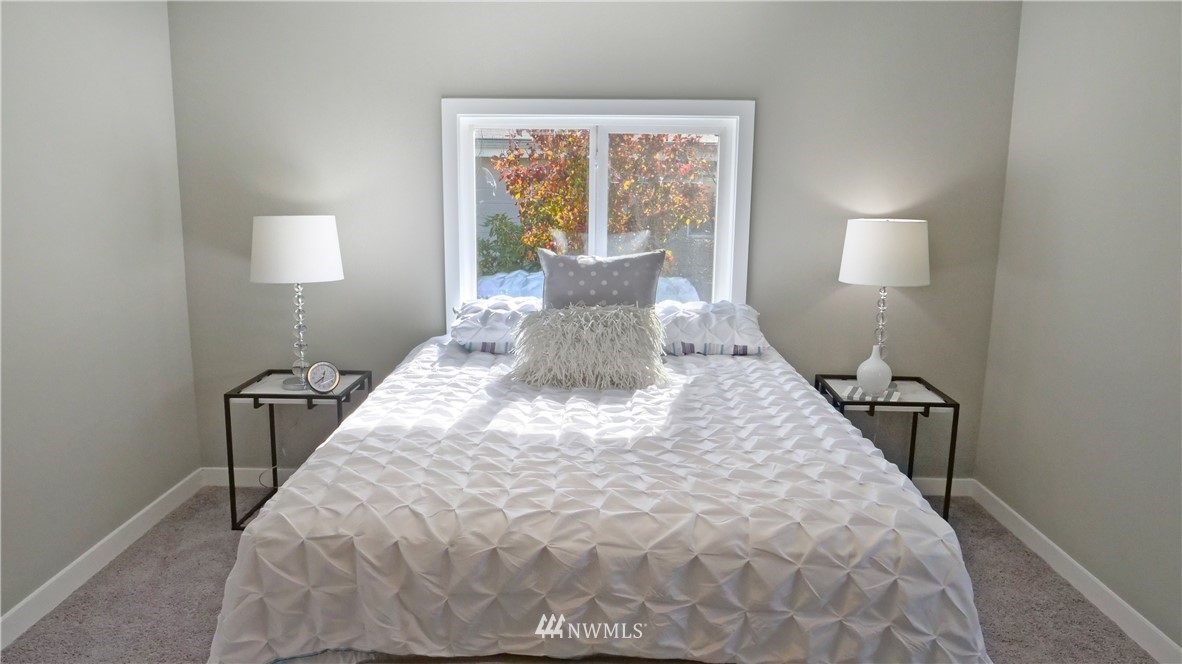 1128 Lake View Circle Bothell, WA 98021 - Photo 14 of 25 a bed sitting in a bedroom next to a window