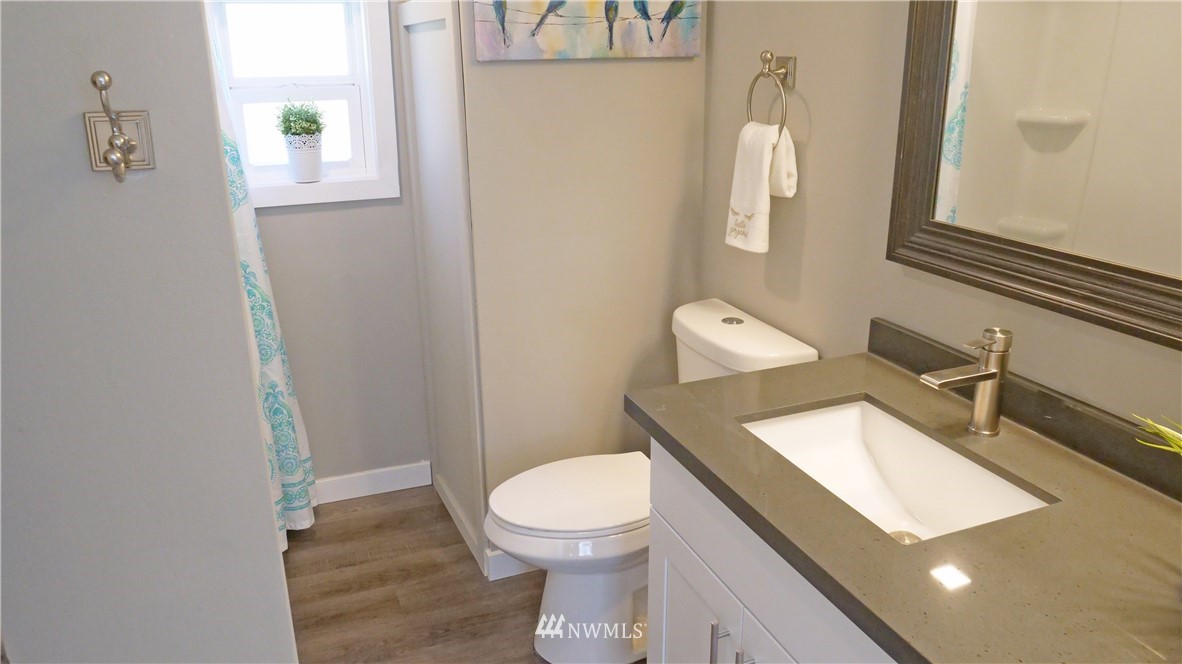 1128 Lake View Circle Bothell, WA 98021 - Photo 16 of 25 a white toilet sitting next to a bathroom sink
