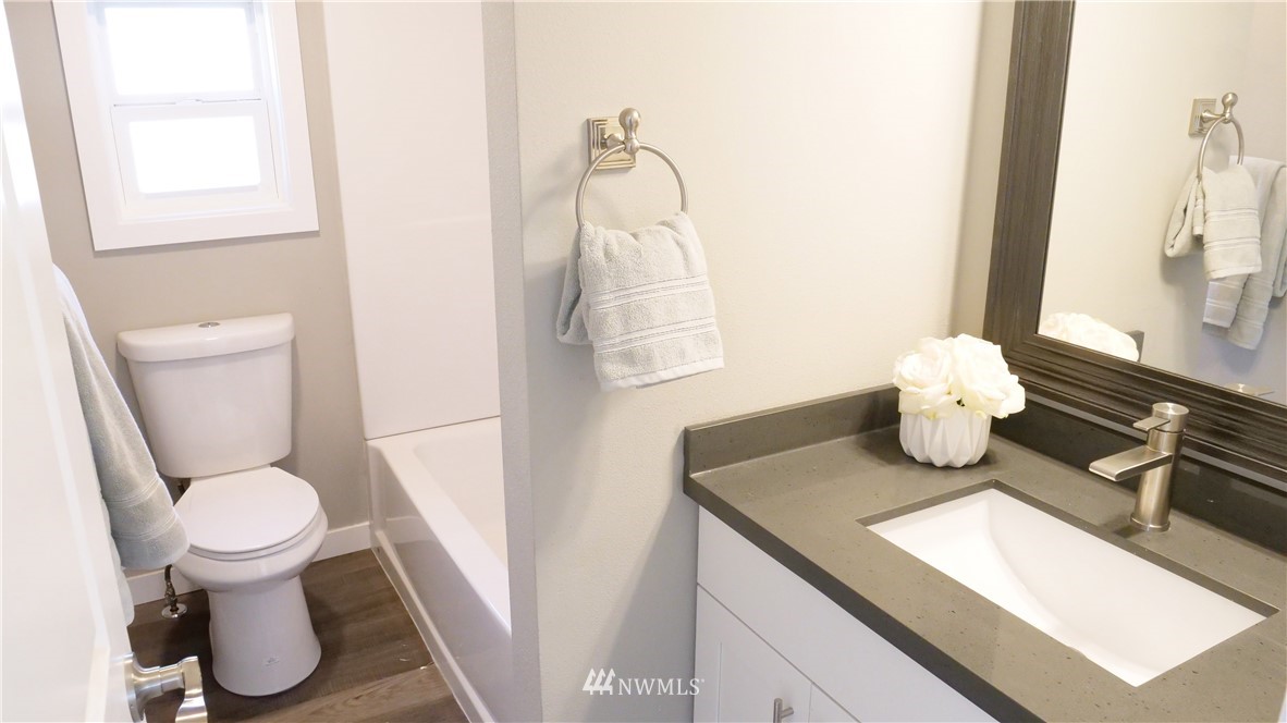1128 Lake View Circle Bothell, WA 98021 - Photo 18 of 25 a bathroom with a toilet sink and mirror