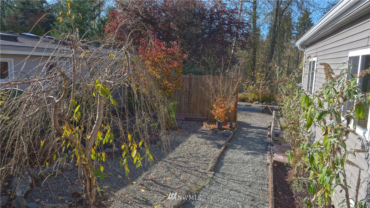 1128 Lake View Circle Bothell, WA 98021 - Photo 23 of 25 a view of a yard with plants and trees