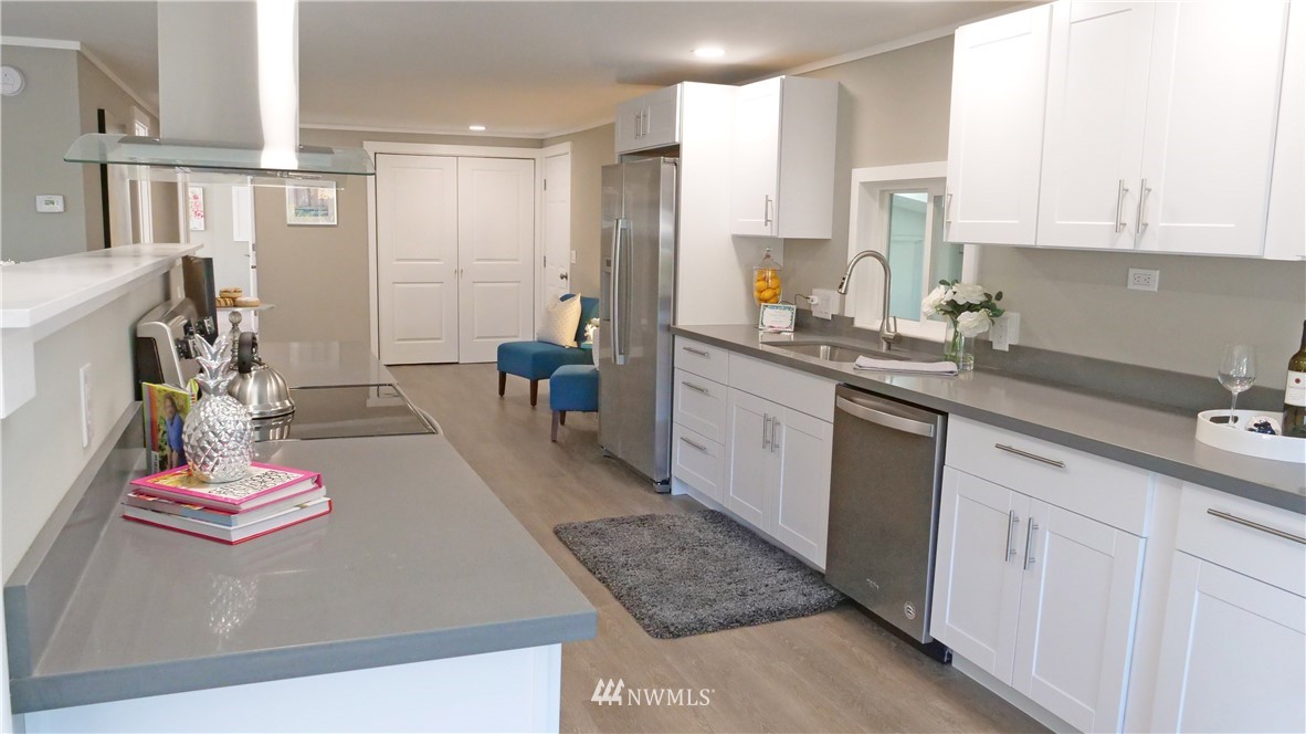 1128 Lake View Circle Bothell, WA 98021 - Photo 7 of 25 a kitchen with stainless steel appliances granite countertop a sink dishwasher stove and cabinets