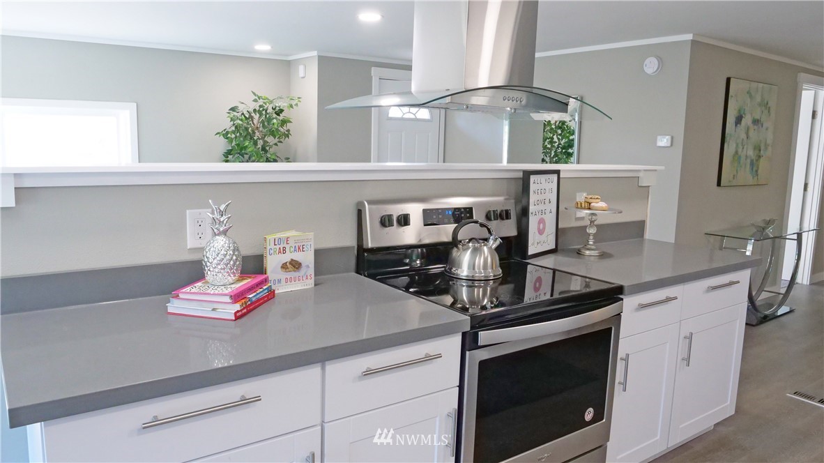 1128 Lake View Circle Bothell, WA 98021 - Photo 8 of 25 a kitchen with kitchen island a sink appliances and cabinets