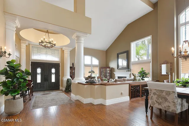a view of a kitchen with a sink and large window