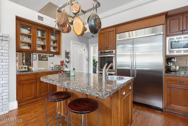 a living room with furniture fireplace and wooden floor
