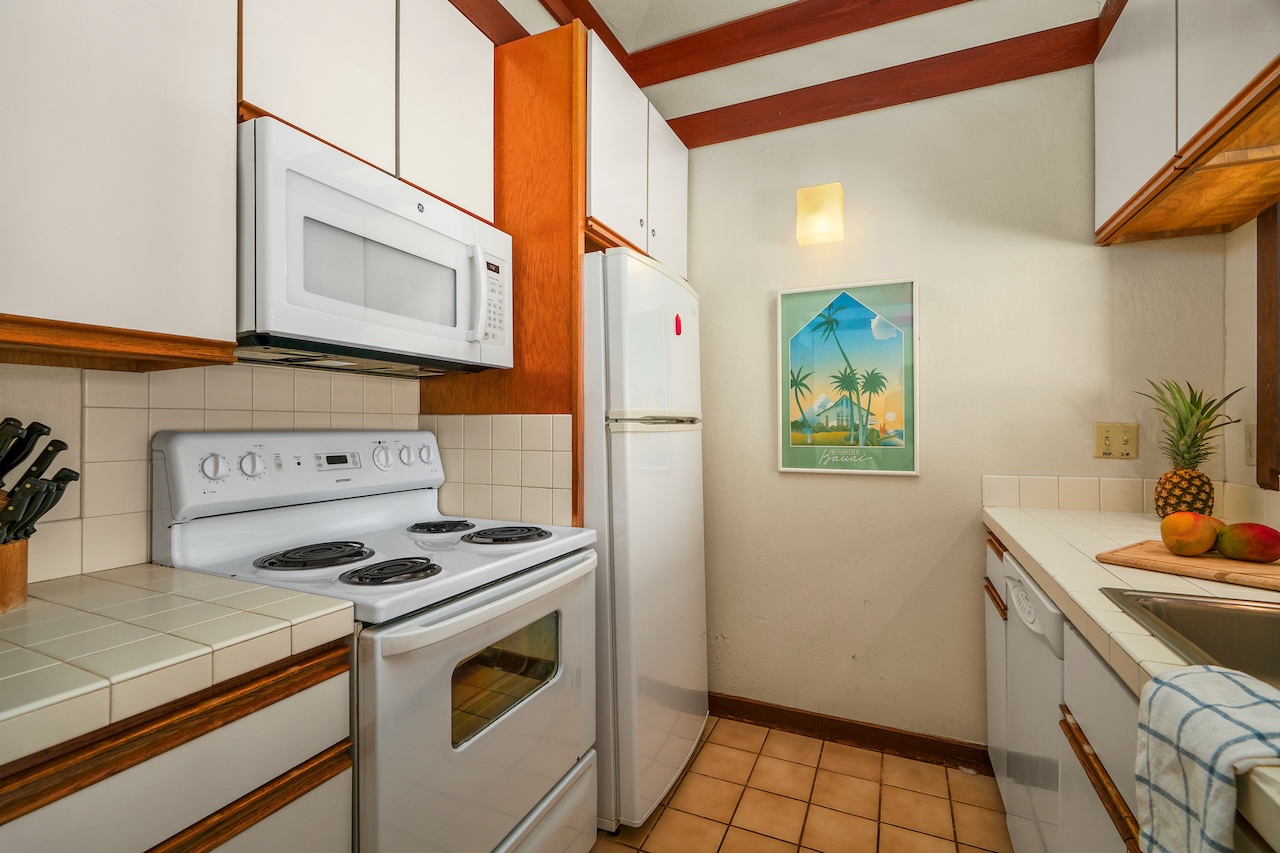 2253 Poipu Road, Unit 62 Koloa, HI 96756 - Photo 11 of 19 a kitchen with stainless steel appliances a stove a sink and a refrigerator