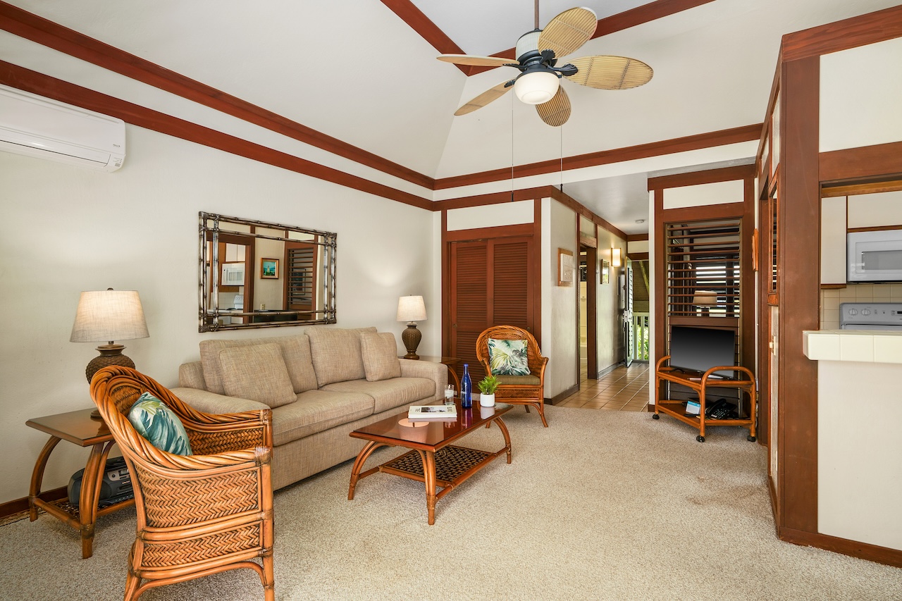 2253 Poipu Road, Unit 62 Koloa, HI 96756 - Photo 2 of 19 a living room with furniture a chandelier fan and a window