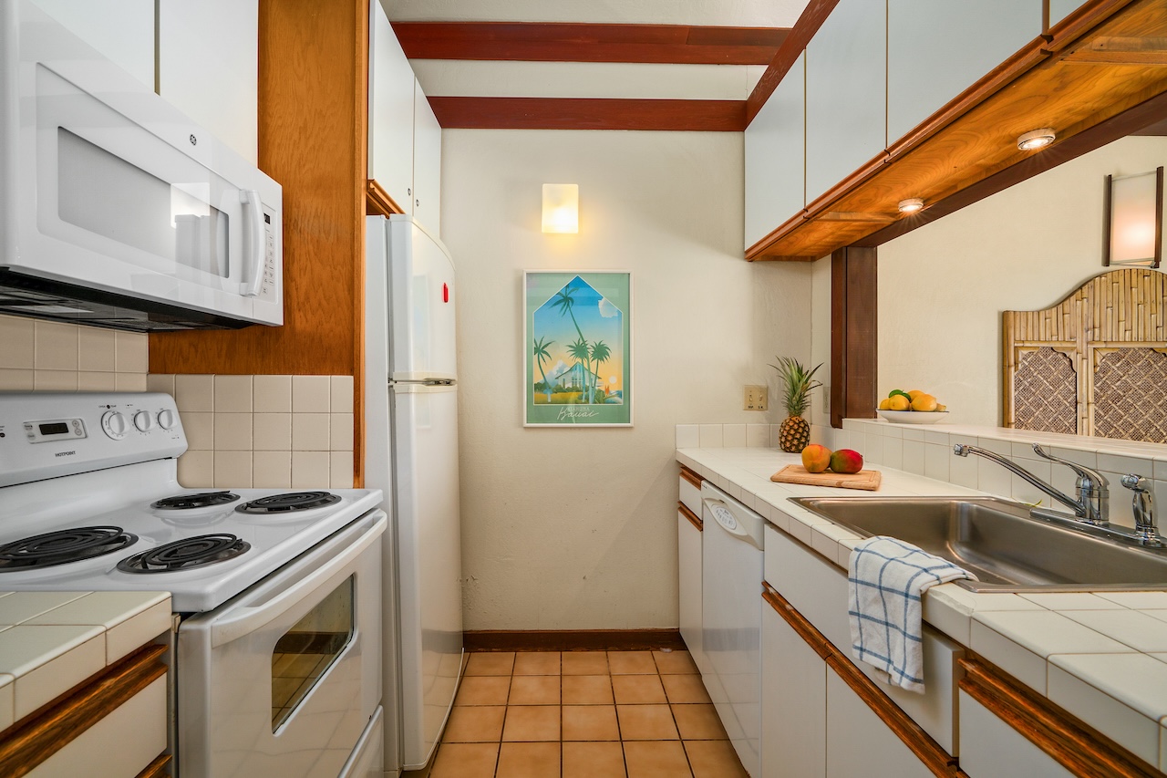 2253 Poipu Road, Unit 62 Koloa, HI 96756 - Photo 8 of 19 a kitchen that has a sink and a stove