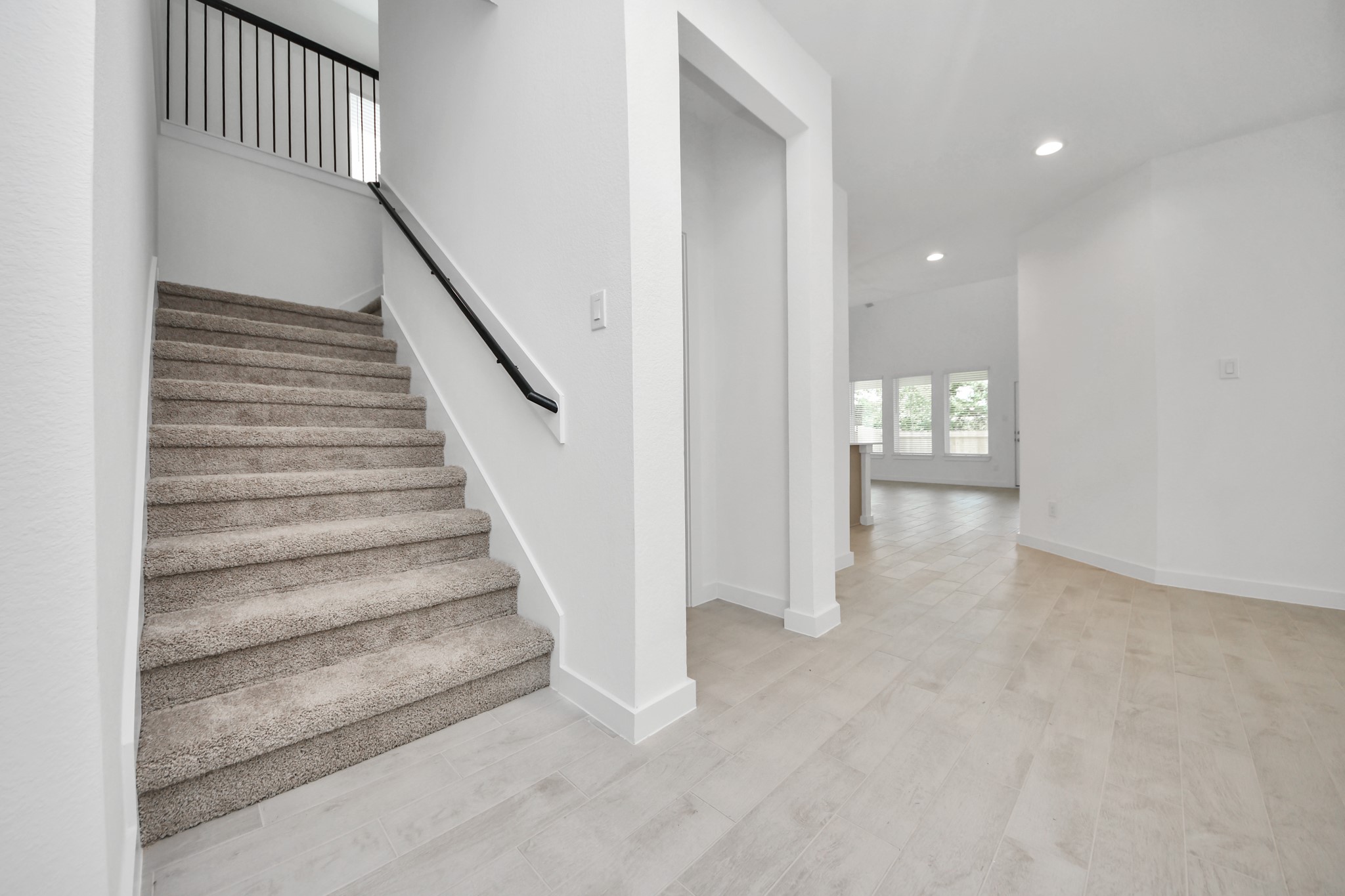 2926 Bury Park Dr Spring Spring, TX 77373 - Photo 23 of 40 Come upstairs and enjoy a day of leisure in this fabulous game room! This is the perfect hangout spot or adult game room! Features plush carpet, high ceilings, custom paint and windows for plenty of natural light.