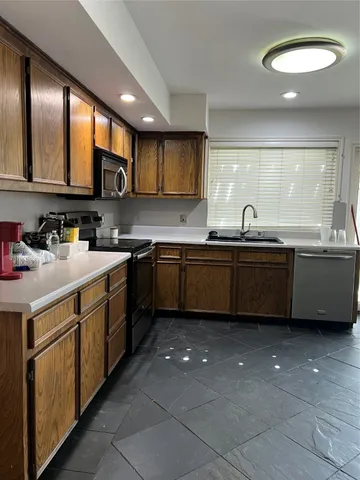 a kitchen with a sink a stove and cabinets