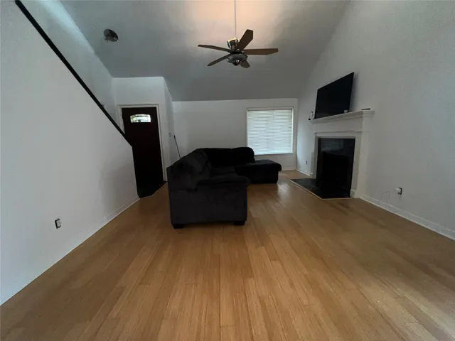 a bedroom with a bed and a ceiling fan