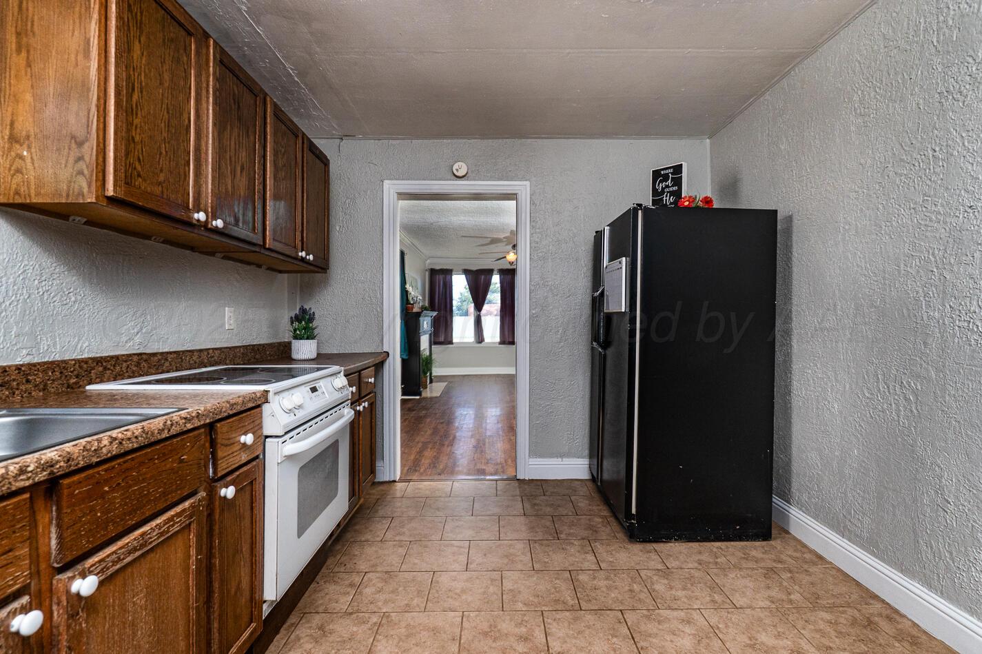 8015 Upton Road Amarillo, TX 79119 - Photo 6 of 16 a kitchen with stainless steel appliances granite countertop a refrigerator and a stove