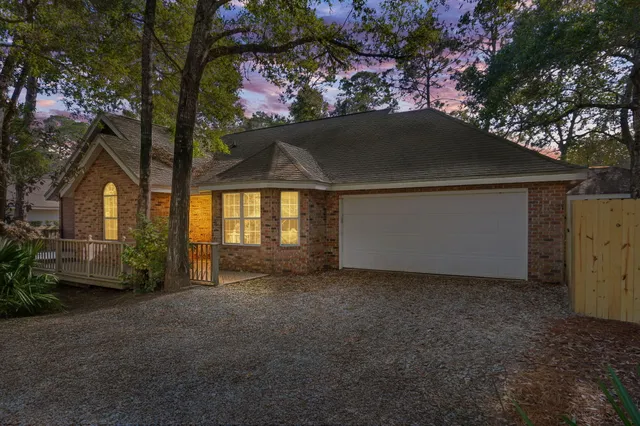 an empty room with windows and fireplace