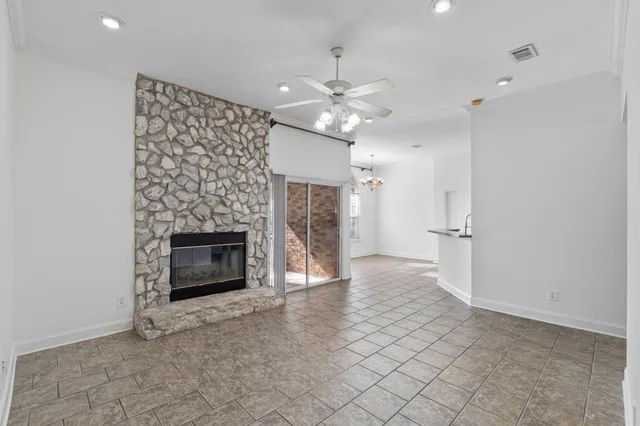 a view of a room with a large window and chandelier