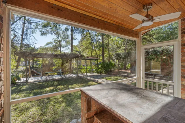 a view of a patio with table and chairs and potted plants