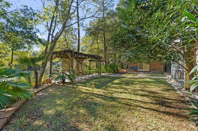 a view of a house with a yard and sitting area
