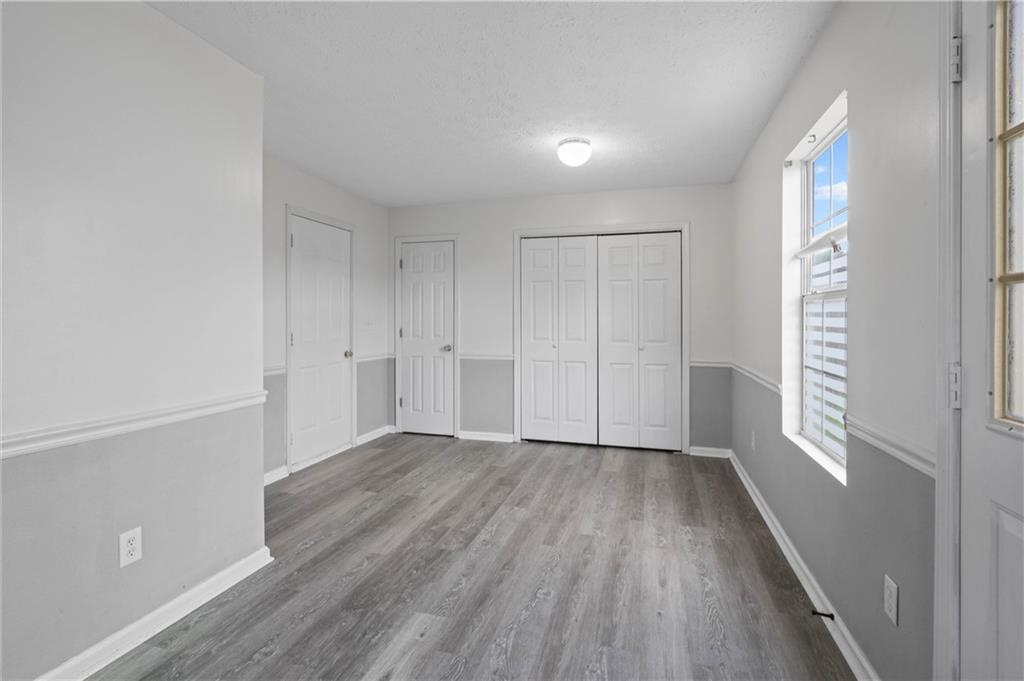 57 Inverness Trace Riverdale, GA 30274 - Photo 12 of 30 a view of an empty room with wooden floor and a window
