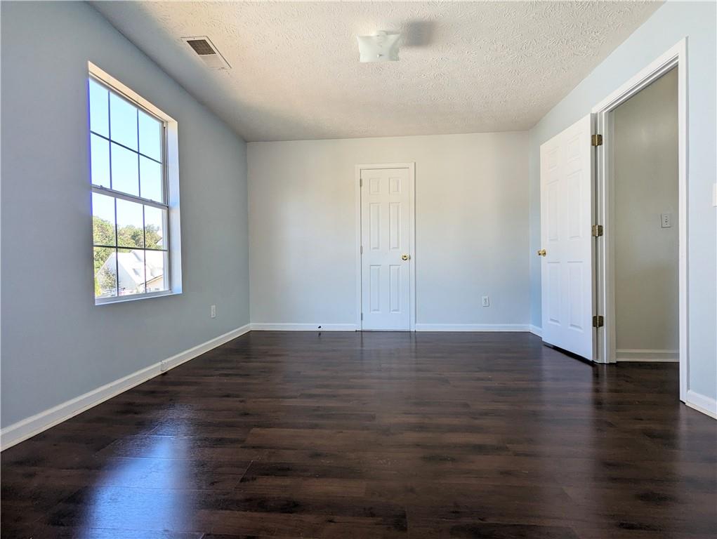 57 Inverness Trace Riverdale, GA 30274 - Photo 16 of 30 an empty room with wooden floor and windows