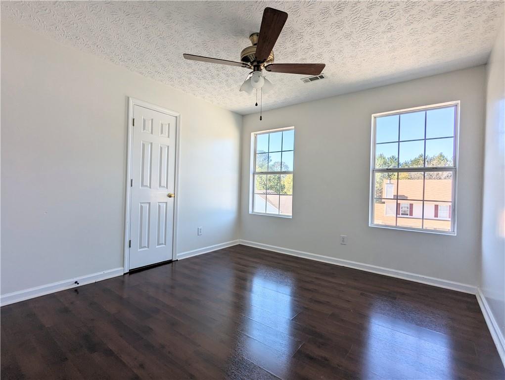 57 Inverness Trace Riverdale, GA 30274 - Photo 18 of 30 a view of empty room with wooden floor and fan