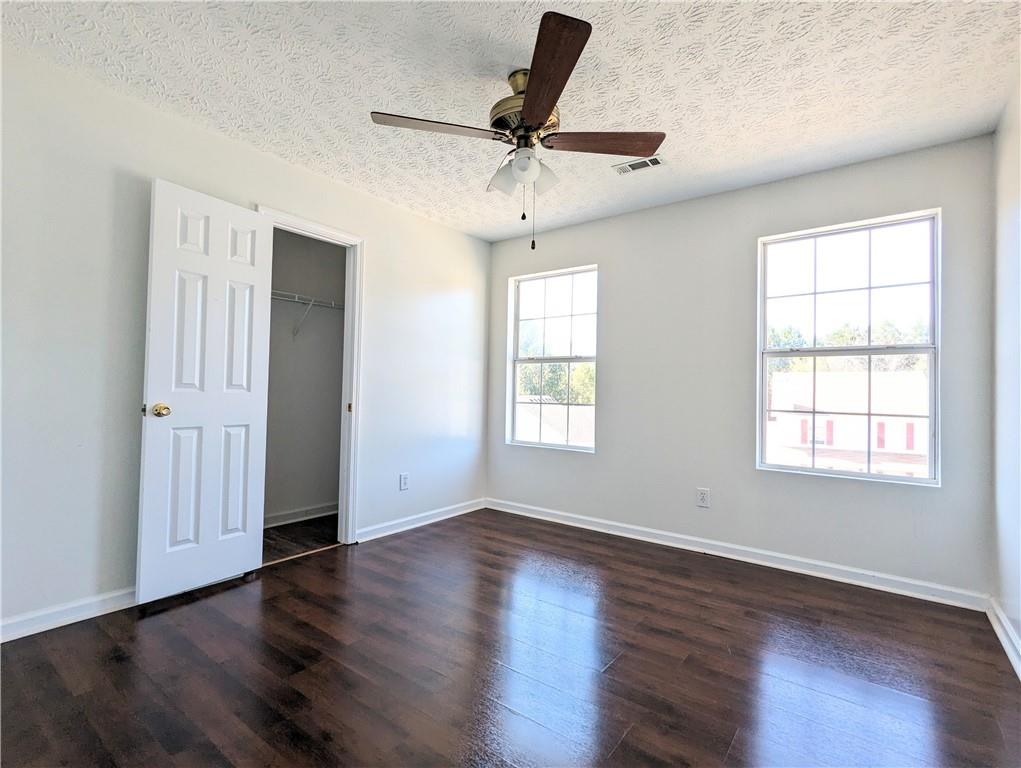 57 Inverness Trace Riverdale, GA 30274 - Photo 27 of 30 an empty room with wooden floor ceiling fan and windows