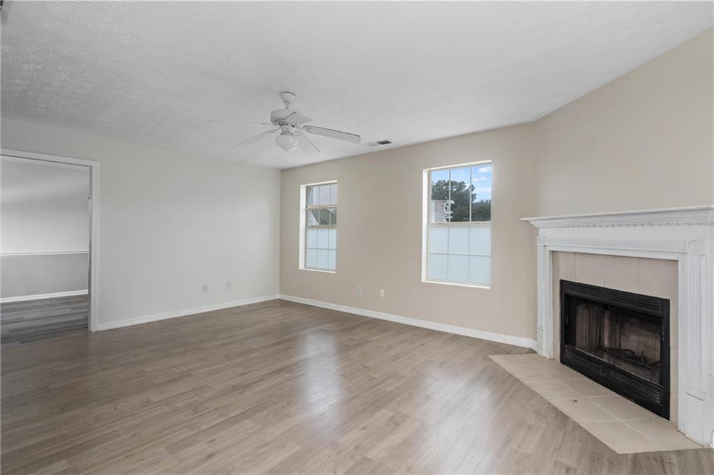 57 Inverness Trace Riverdale, GA 30274 - Photo 4 of 30 wooden floor fireplace and windows in an empty room