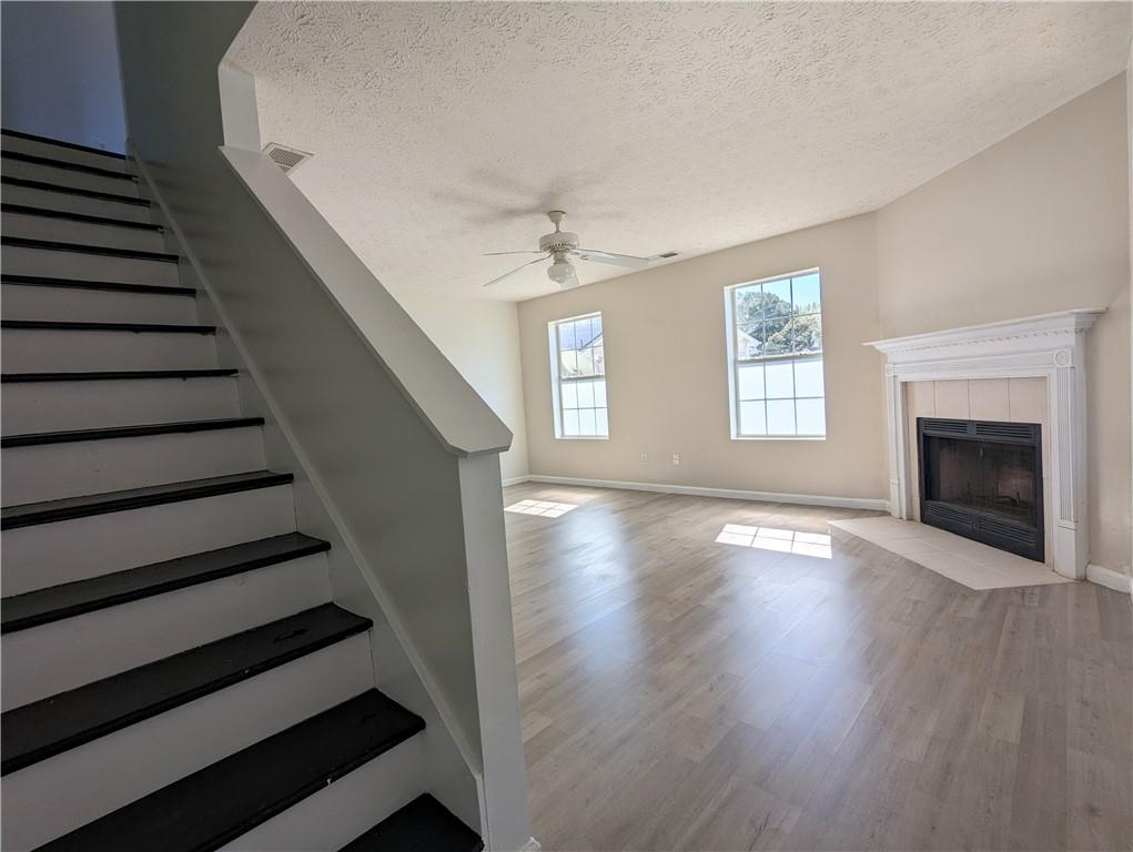 57 Inverness Trace Riverdale, GA 30274 - Photo 7 of 30 a view of an empty room with wooden floor fireplace and a window
