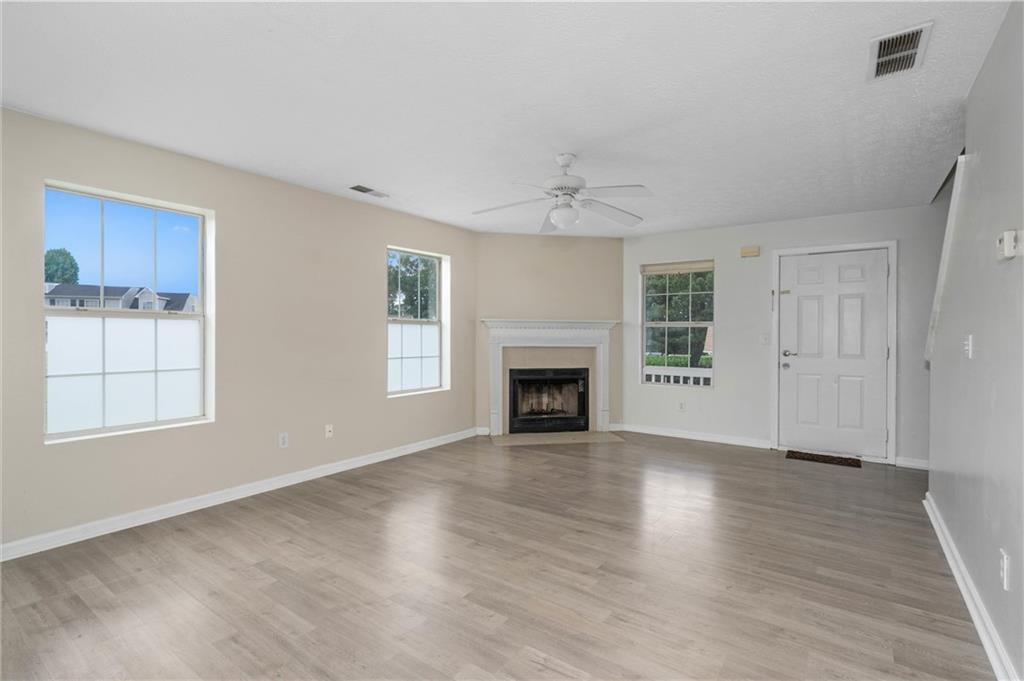 57 Inverness Trace Riverdale, GA 30274 - Photo 8 of 30 an empty room with windows and fireplace