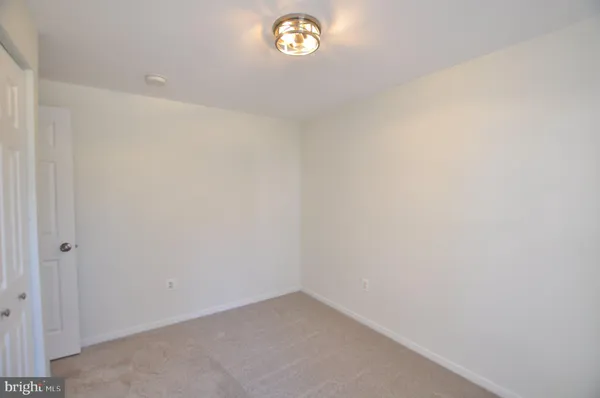 a view of an empty room with stairs and ventilation