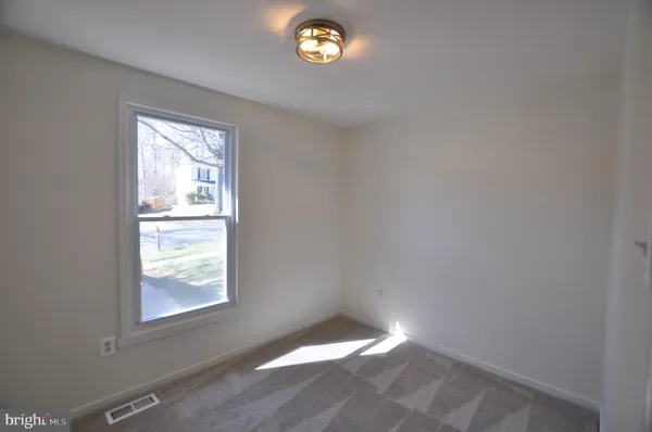 a view of an empty room with stairs