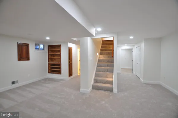 a bathroom with a sink and mirror with toilet
