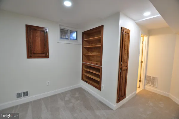 wooden floor in an empty room with a mirror