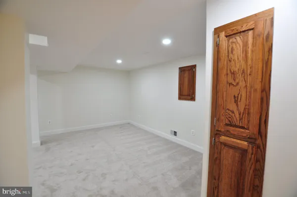 a view of a room with wooden floor and furniture