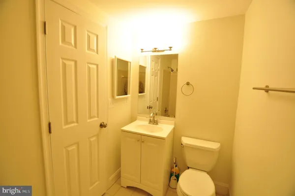 a view of a swimming pool with a patio and wooden fence