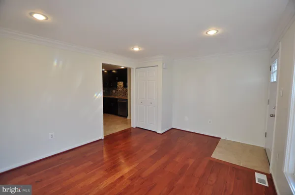 a view of an empty room with wooden floor