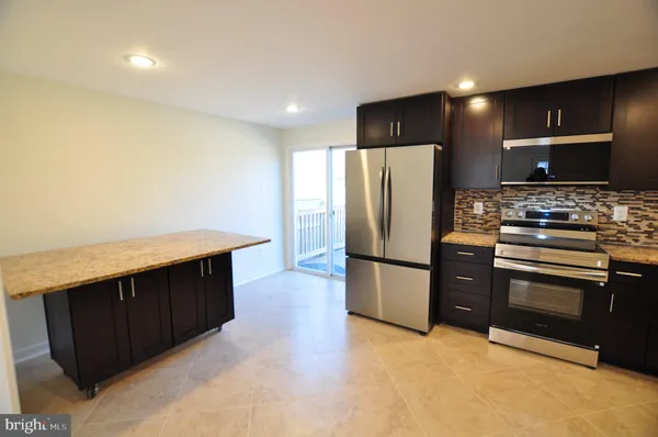 a kitchen with stainless steel appliances a refrigerator and a stove