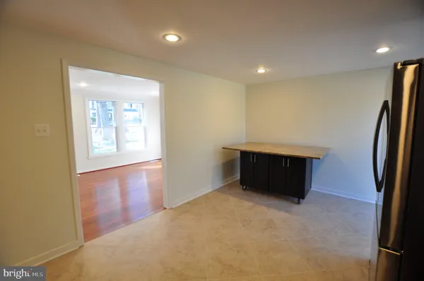 a view of an empty room and a window