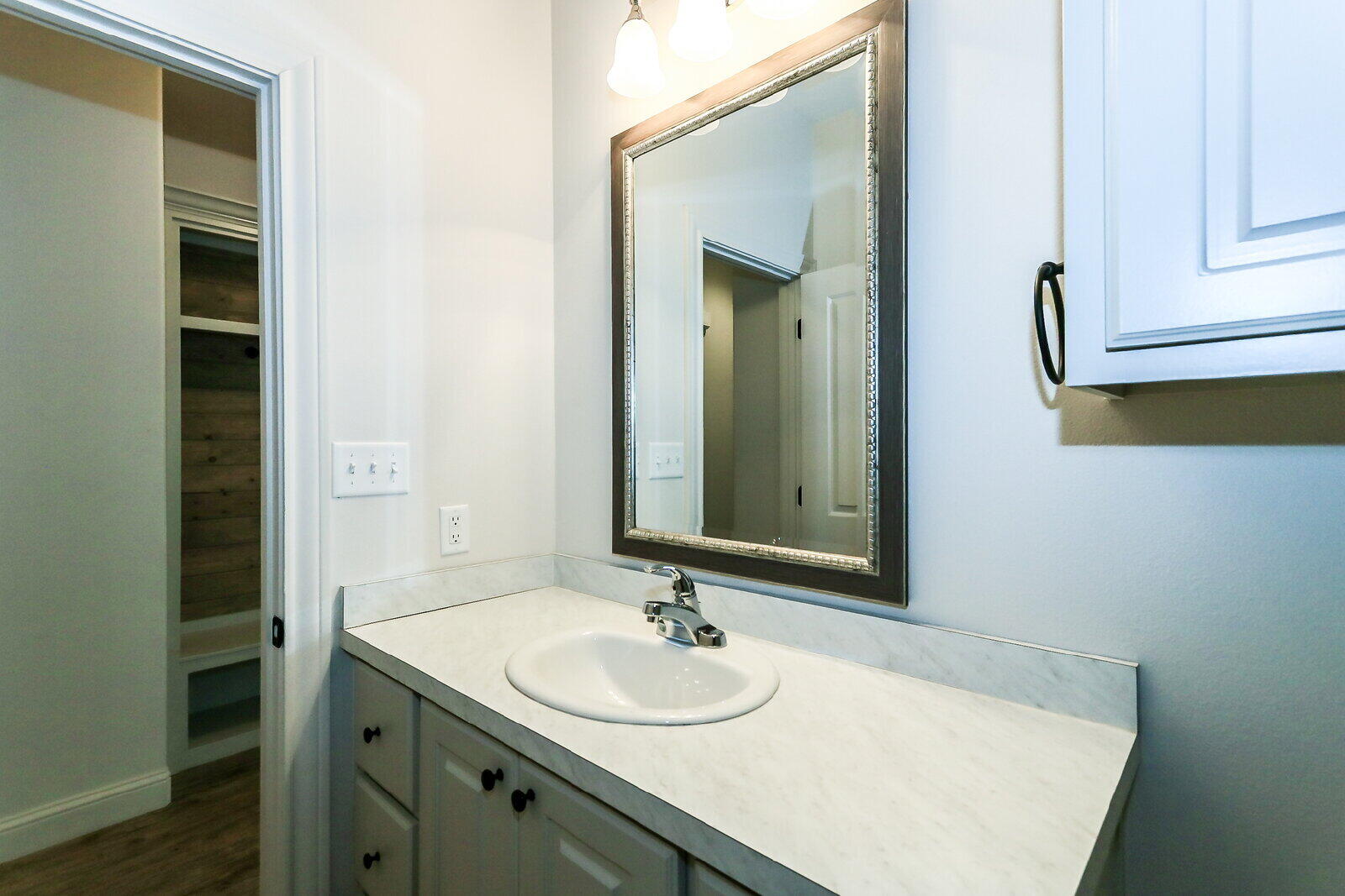 11104 Acme Avenue, Unit A Lubbock, TX 79423 - Photo 14 of 15 a bathroom with a sink and a mirror