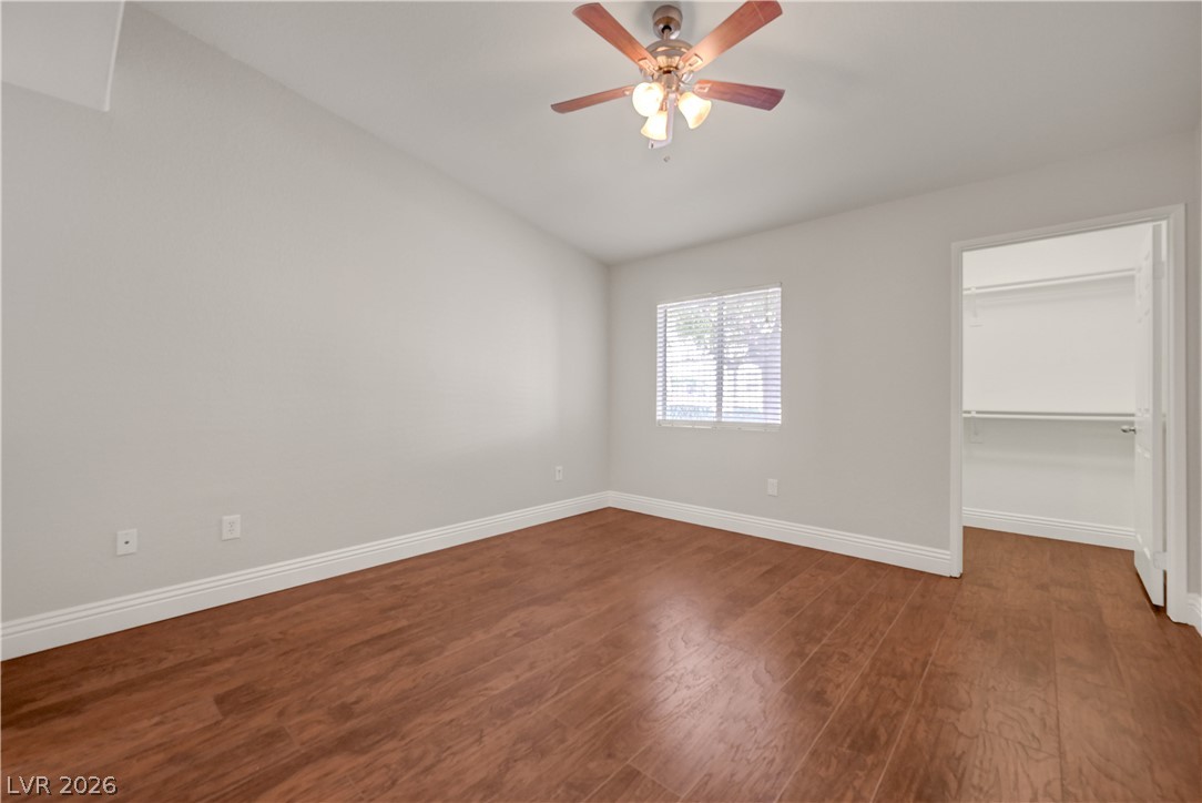 7885 West Flamingo Road, Unit 1050 Las Vegas, NV 89147 - Photo 20 of 62 Hardwood floors and a well-lit window define this inviting bedroom space.