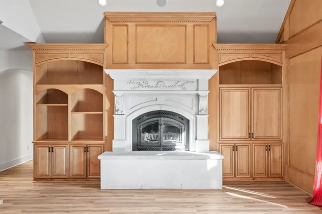 a living room with a fireplace furniture and a window