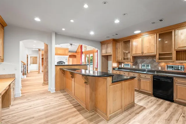 a kitchen with stainless steel appliances granite countertop sink stove and refrigerator