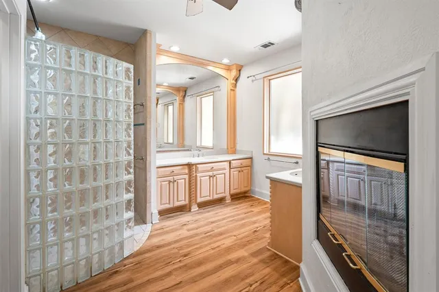a living room with stainless steel appliances furniture and a fireplace