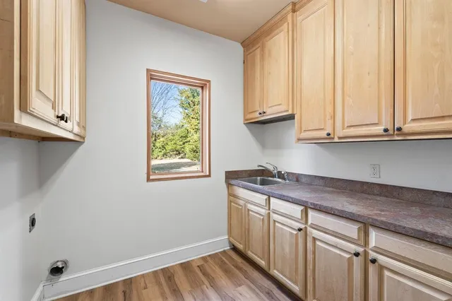 a kitchen with stainless steel appliances granite countertop white cabinets and window