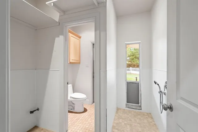 a bathroom with a granite countertop sink a toilet and shower