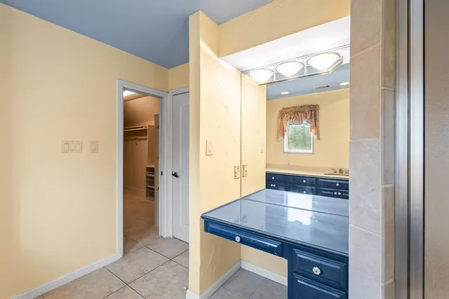 a room that has a mirror and a wooden floor