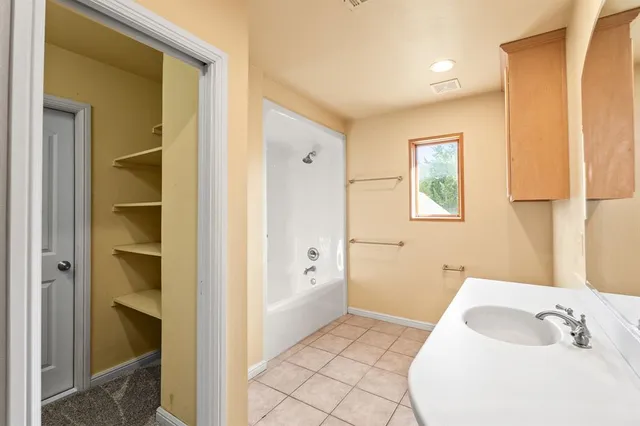 a bathroom with a bathtub and a sink